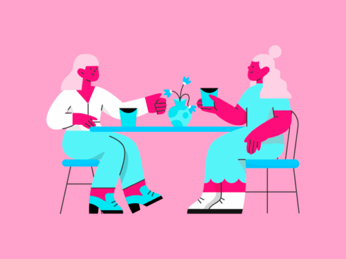 Duas mulheres se divertindo em um café colorido.