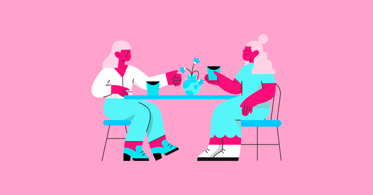 Duas mulheres se divertindo em um café colorido.
