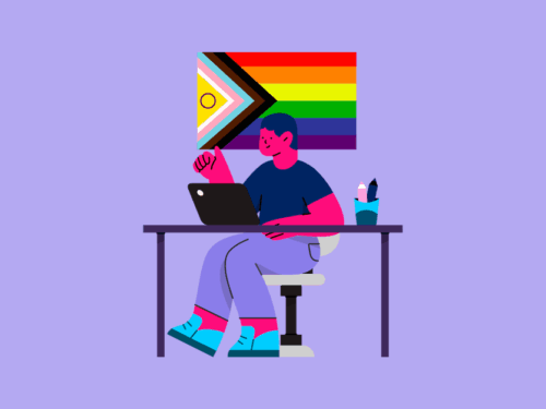 Pessoa trabalhando em laptop com arte LGBTQIAPN+ ao fundo